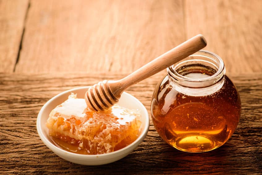 Honey with wooden honey dipper