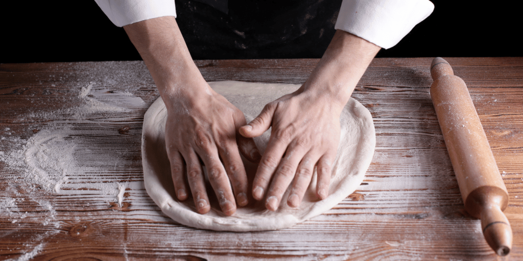 hand forming pizza dough