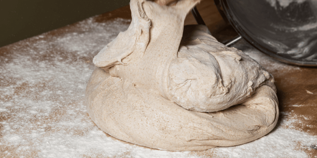 slack dough or wet pizza dough on floured board