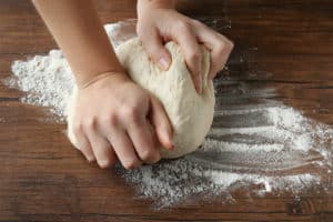 Kneading pizza dough by hand