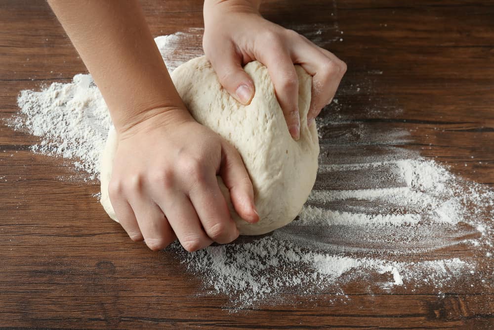 Kneading pizza dough by hand image
