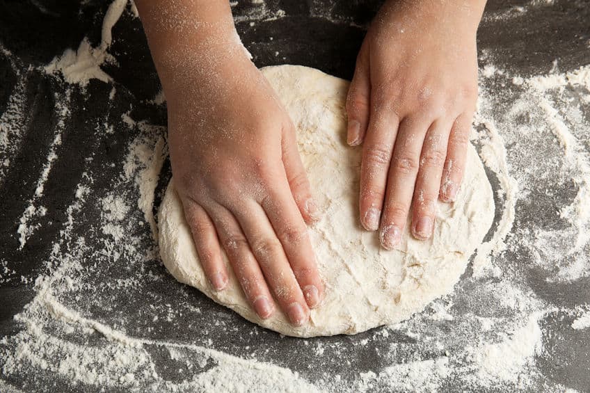 stretching pizza dough to make circle