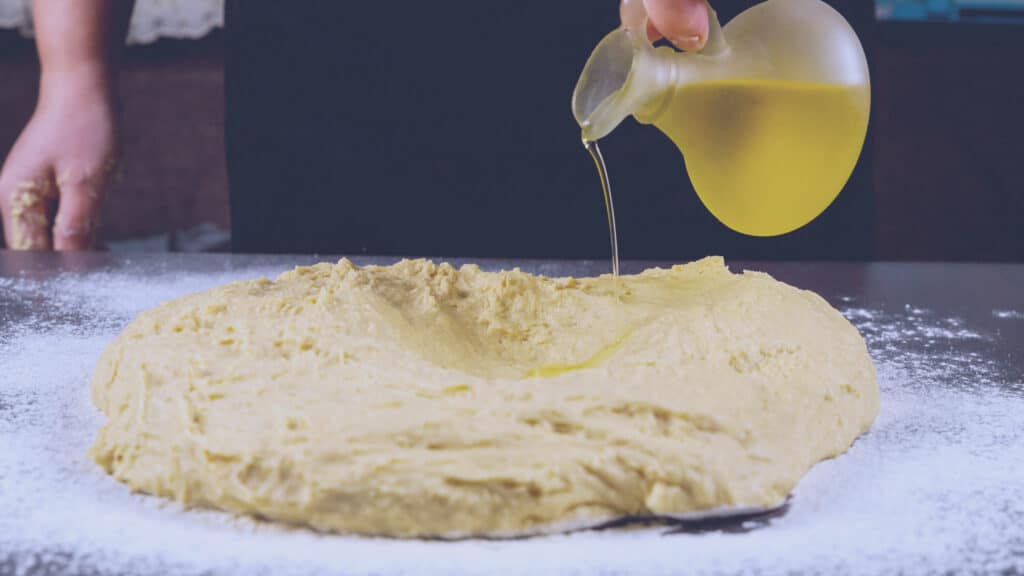 Adding oil to mixed dough