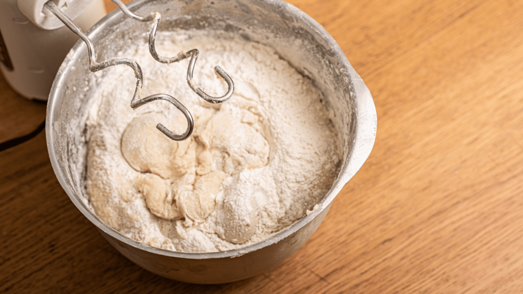 mixing pizza dough with hand mixer